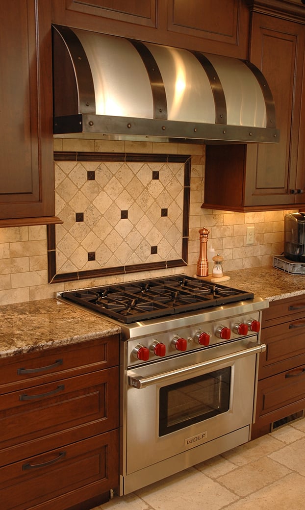 Create a focal point with your hood by using a custom awning-shaped under-cabinet hood. These can be customized in all sorts of ways to match your kitchen.