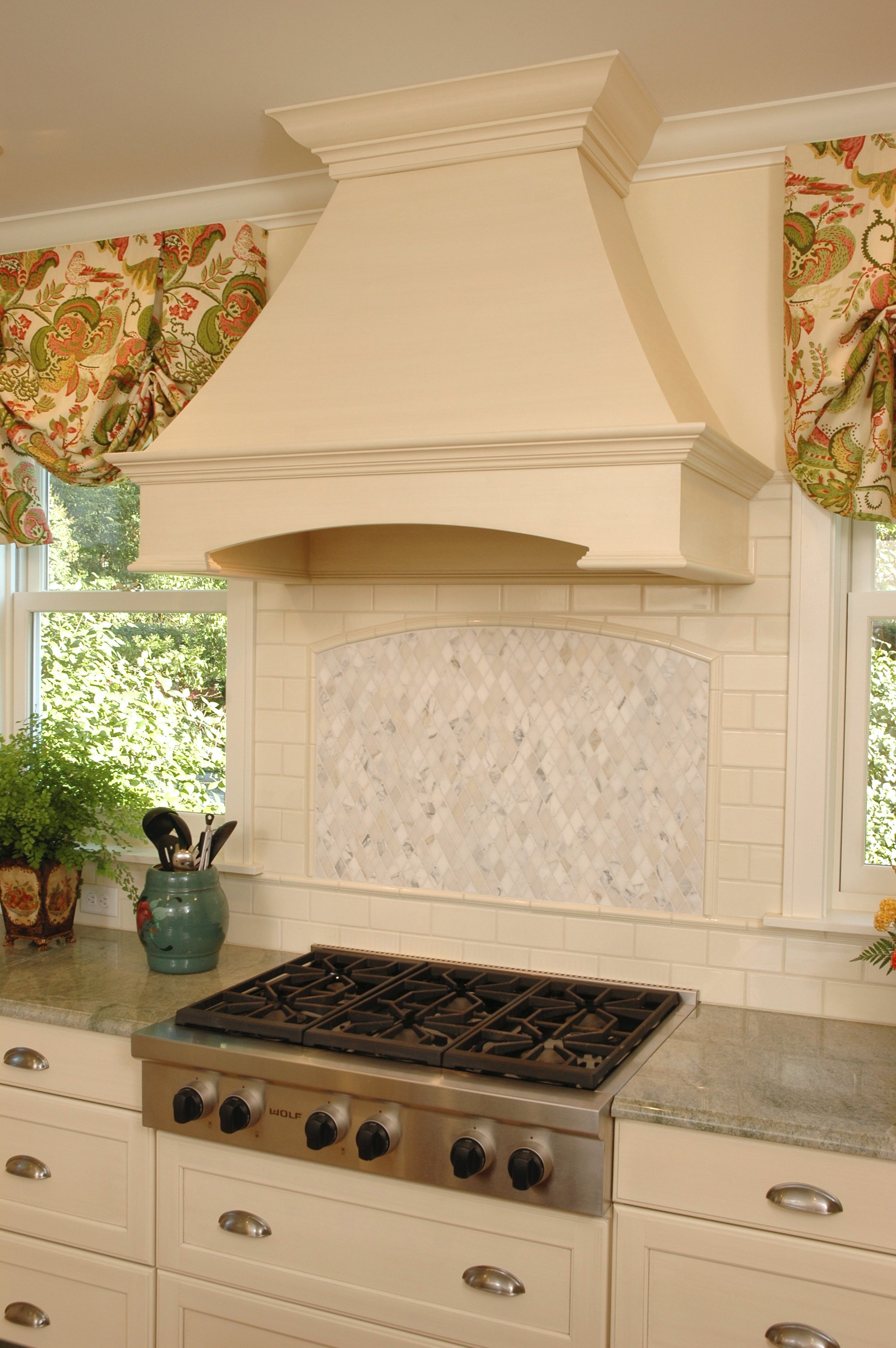 A chimney wood hood like this one can be customized to fit the style and cabinets of your kitchen.