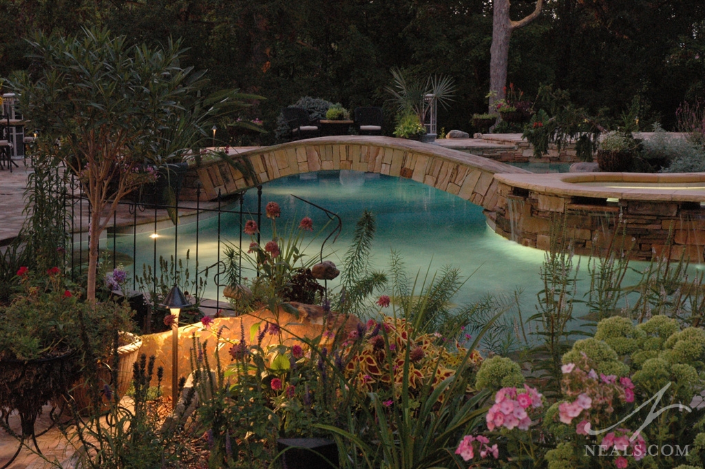 Lighting inside the pool and inserted into the surrounding landscape helps keep this outdoor space safe in the twilight hours.