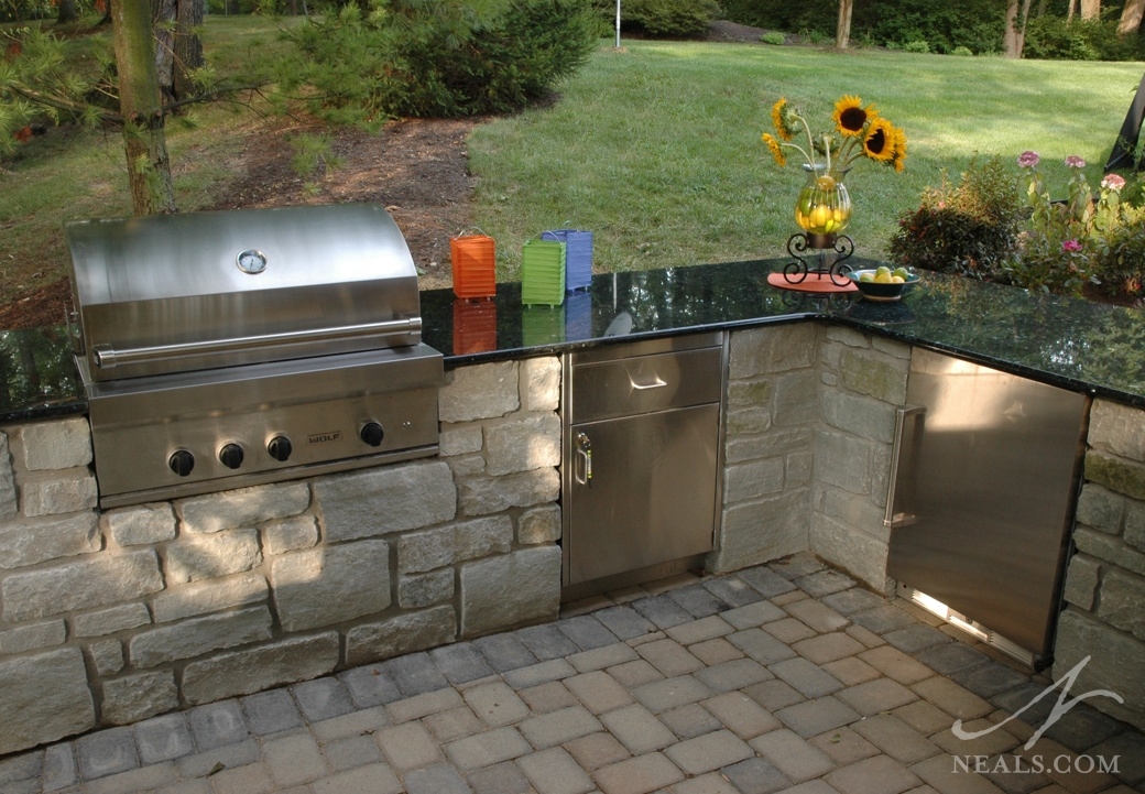 The beverage refrigerator in this Neal's project works in conjuction with a grill and storage to create a well-appointed outdoor kitchen.