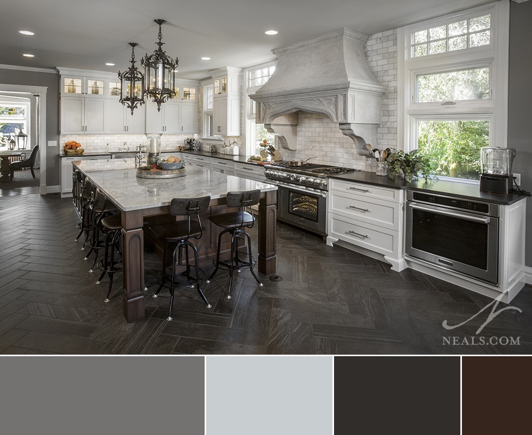 Kitchen that uses a neutral contrast color scheme to visually reduce the scale of the space.