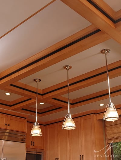 A modern take on the coffered ceiling, a black detail in the trimwork carries over to the cabinetry.