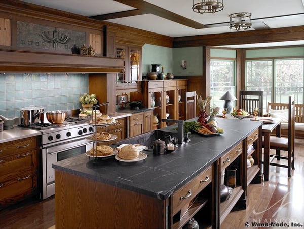 Craftsman style is known for warm, earthy colors, well-crafted woodwork, and artistic details, as seen in this kitchen by Wood-Mode Cabinetry.