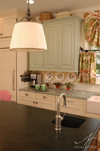 To create an eclectic look, each of the cabinet styles in this cottage-style kitchen use different hardware.