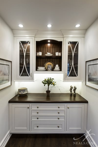 Display cabinets in this butler's pantry hold extra serveware.