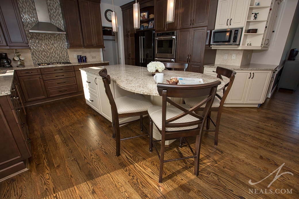A table built into the island counter in this Mason kitchen provides a seating area just outside of the work zones.