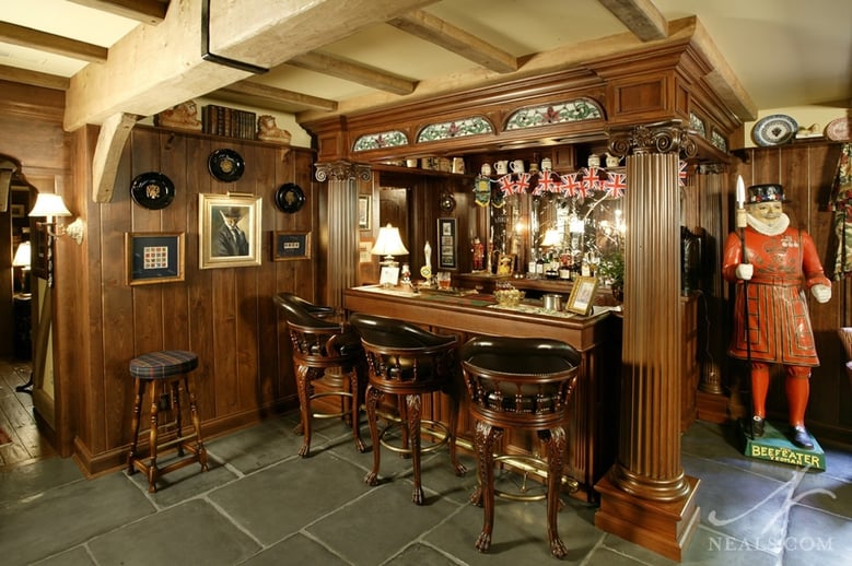 An authentic bar, including seating counter and mirrored back wall, is the cornerstone of this English pub remodel.