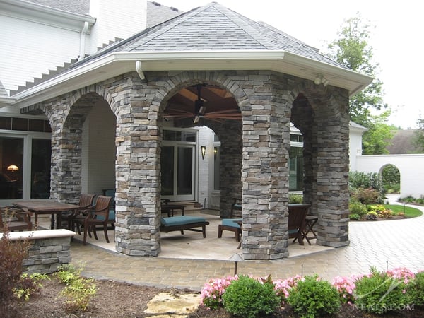 This large-scale stone pavilion acts as a backyard porch, but can easily conform to a variety of guest needs and party sizes.
