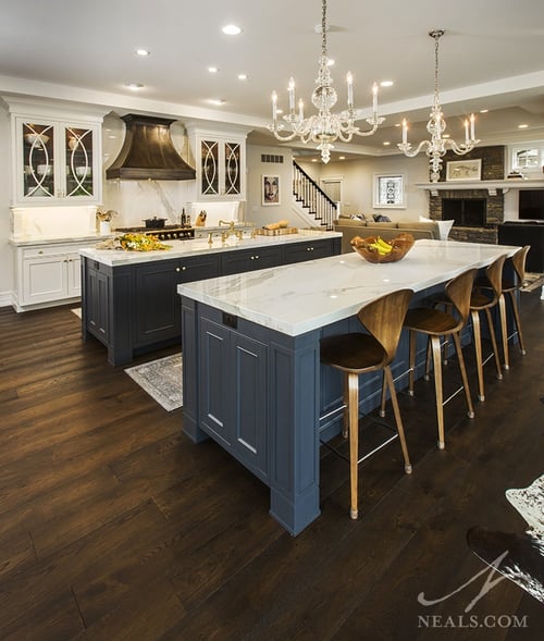 A pair of navy blue islands pull the home's entire scheme together in the kitchen, and change with different layers of light.