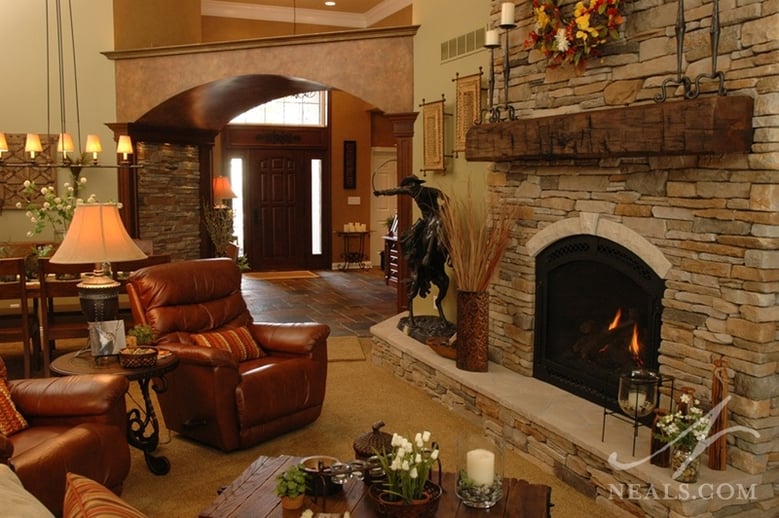 A reclaimed beam was used for the fireplace mantle in this first-floor remodel, and adds a rough detail to this rustic, western-inspired space. 