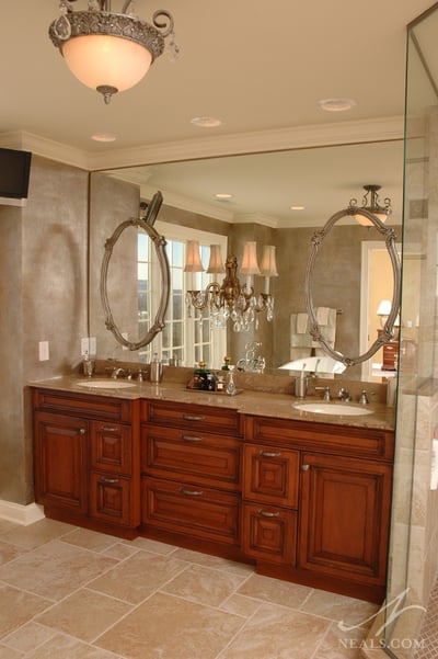 This glamorous double vanity layers mirrors and light for a romantic effect.