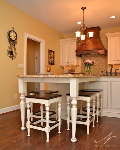 A distressed hardwood floor completes the French Country style of this kitchen.