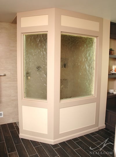 walk-in shower with textured glass windows in a privacy enclosure
