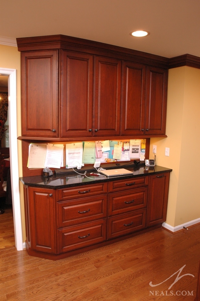 Just off the mudroom entrance, the family communication center in this kitchen addition sports a long cork board for important papers, a power strip for device charging and lots of extra storage.