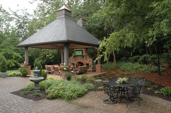 stone and brick fireplace in outdoor shelter