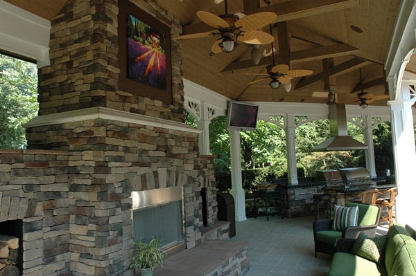 wood-burning stone fireplace in veranda