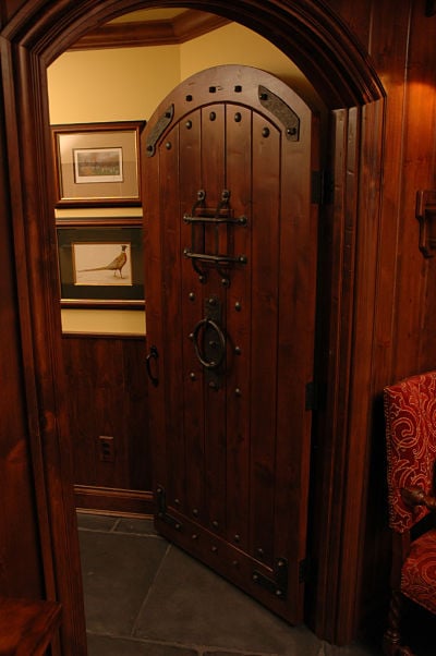 arched entry door with iron trim