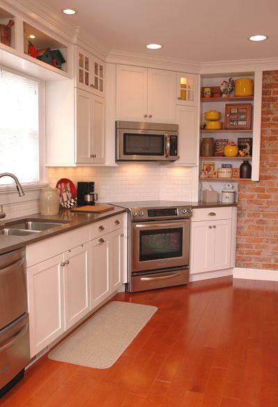 galley kitchen with wide plank flooring