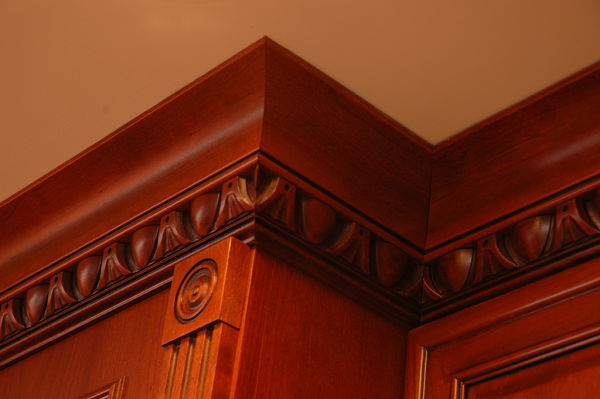 curved crown molding and carved trim embellishments