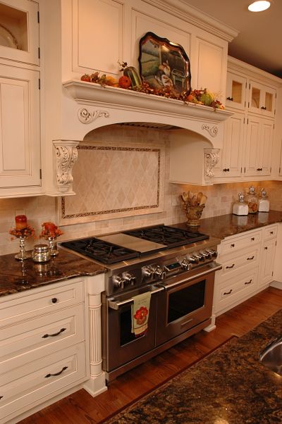 traditional kitchen with custom paneled hood