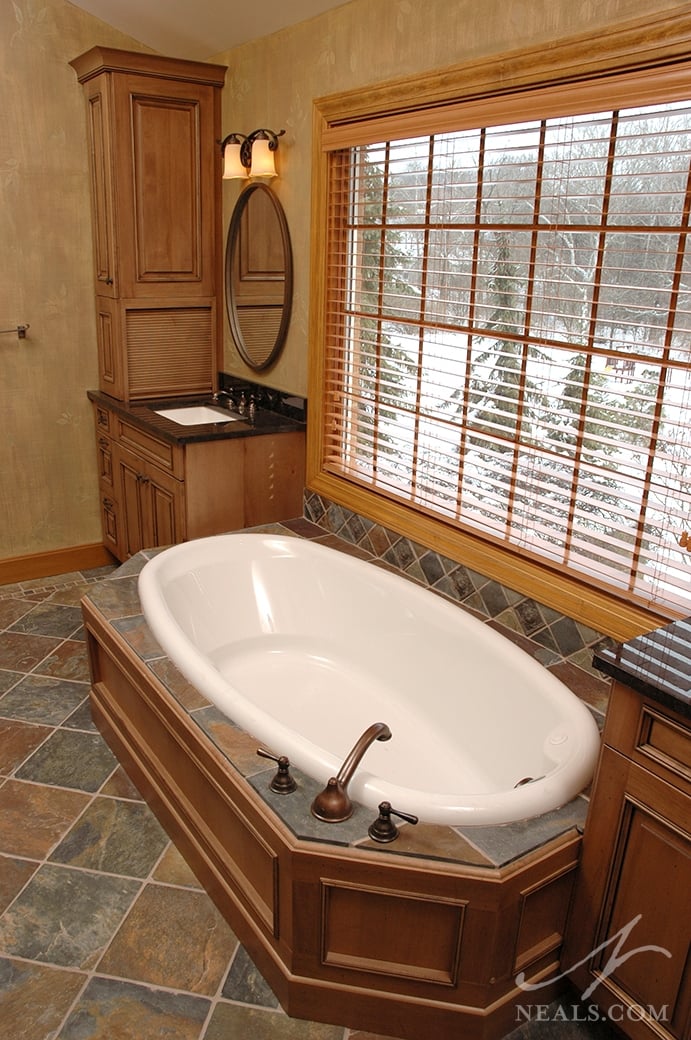 Drop-in tubs fit inside a deck or frame that can be designed to match seamlessly with the room.