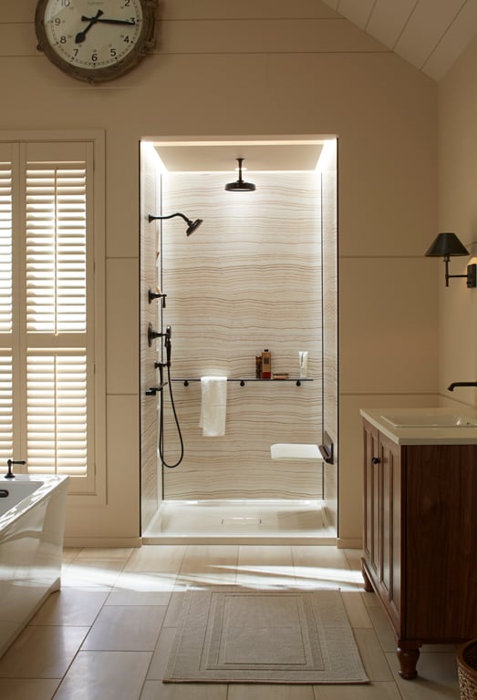 Stone-patterned Kohler Choreograph wall and shower.  Floating shelves can be placed anywhere in the shower to accommodate your needs.