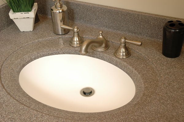 white integrated bathroom sink with gray solid surface counter