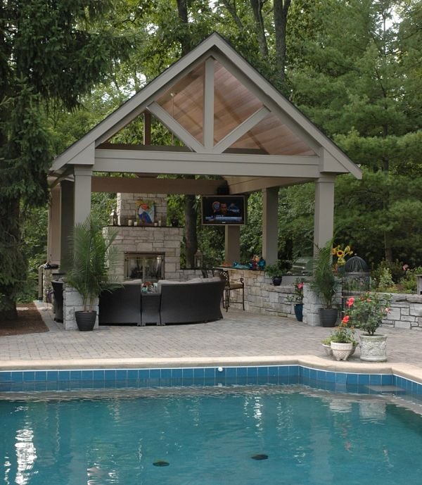 stone fireplace in poolside shelter