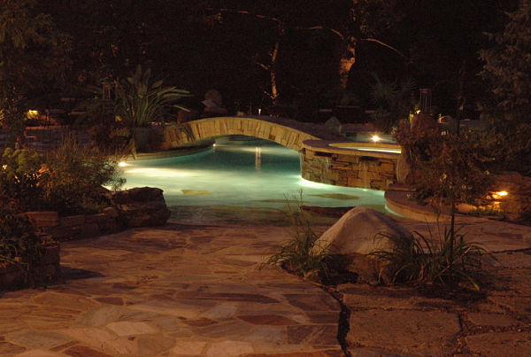 pool and patio with night lighting