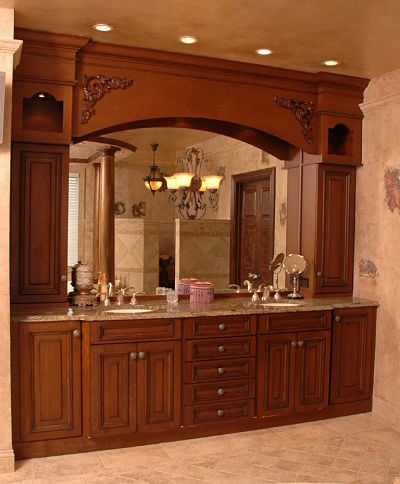 master bath with decorative lighting and large framed mirror