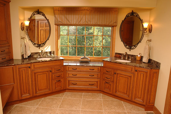 bathroom with cherry cabinets and marble countertops