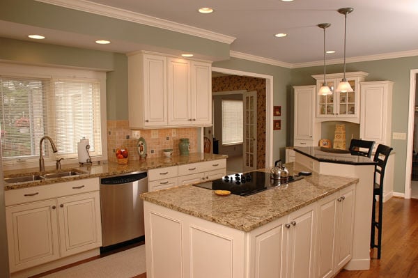 kitchen with white cabinets and tiered island
