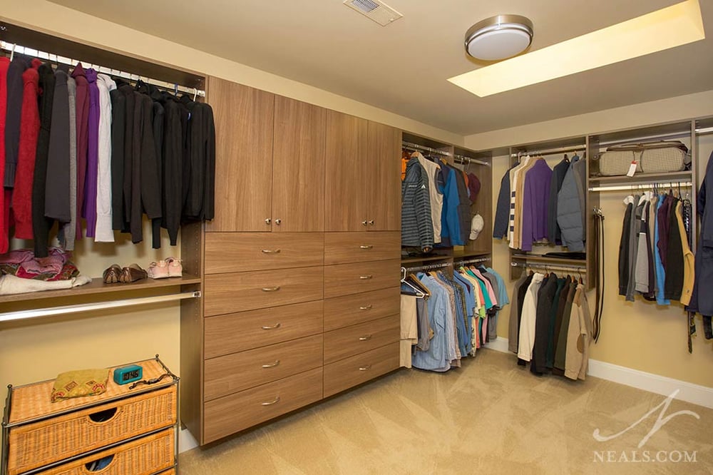This Hyde Park his & her walk in closet uses skylights to add to the room's lighting.