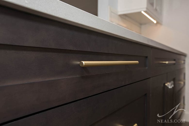 This Colerain kitchen remodel uses gold-finished hardware in a contemporary bar handle style.