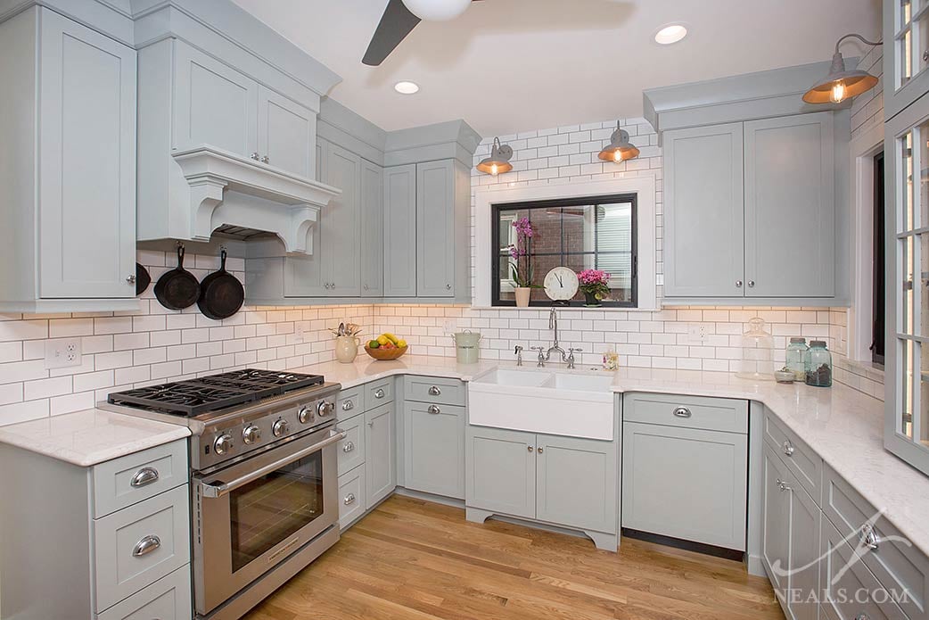 industrial-inspired wall-mounted lights over the kitchen sink and counter