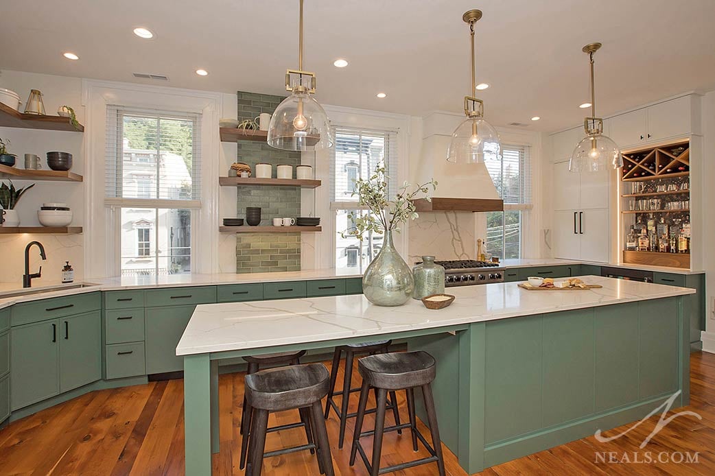 kitchen with green and white recessed cabinets and open shelving