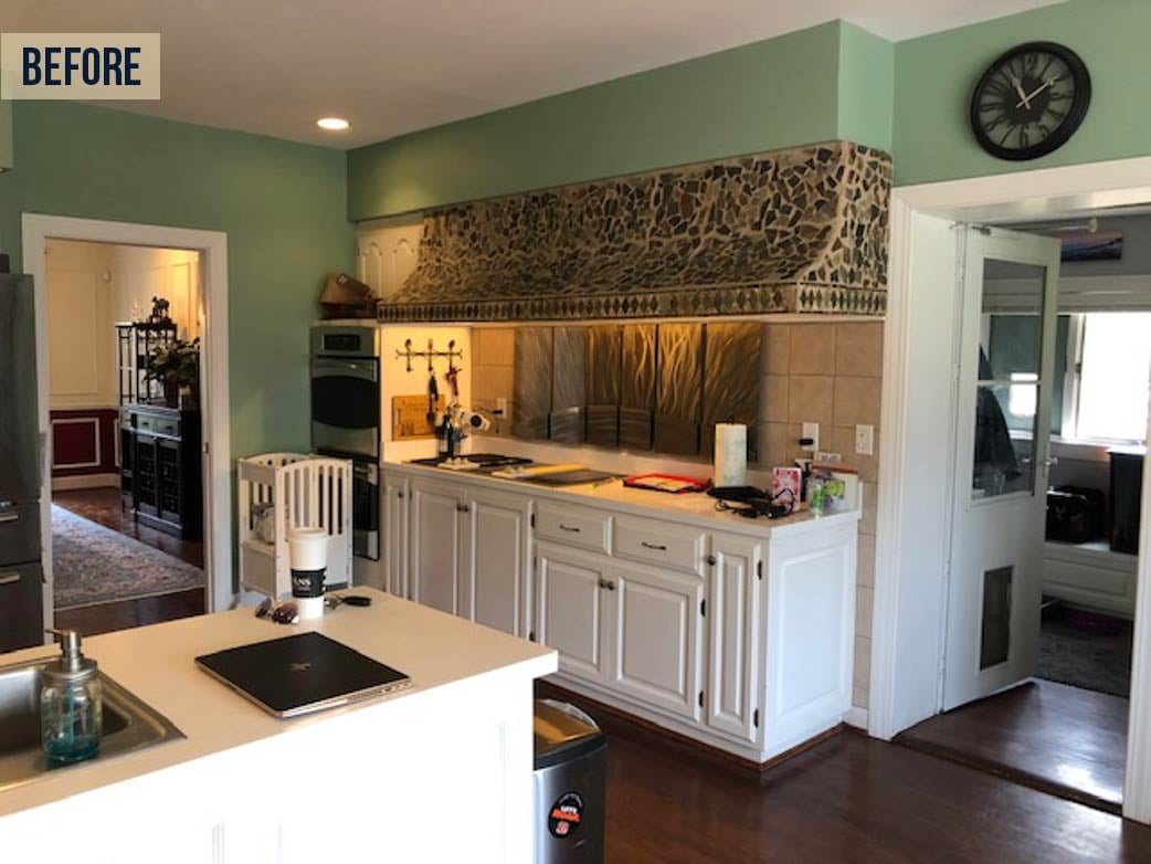 Before image of the kitchen showing the oversized range hood extending over several linear feet