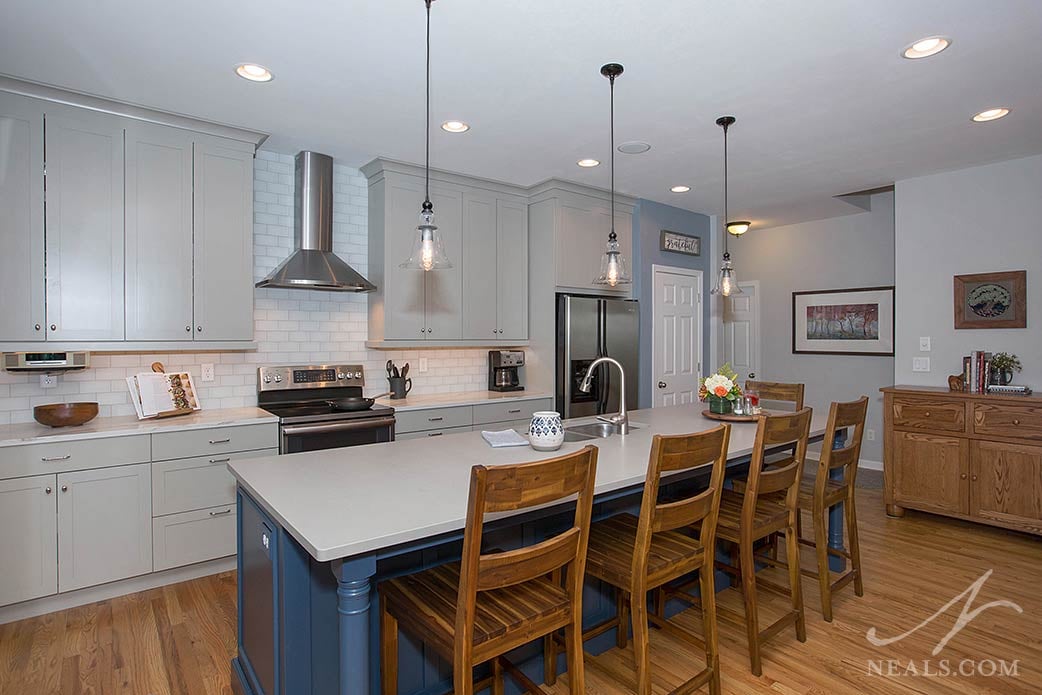 The gray cabinets in this Mason kitchen don't compete with the homeowner taste for warm woods and cool blues.