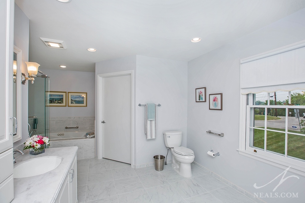 The wide open floor, large doors and open areas in this master bathroom is ideal for aging-in-place.