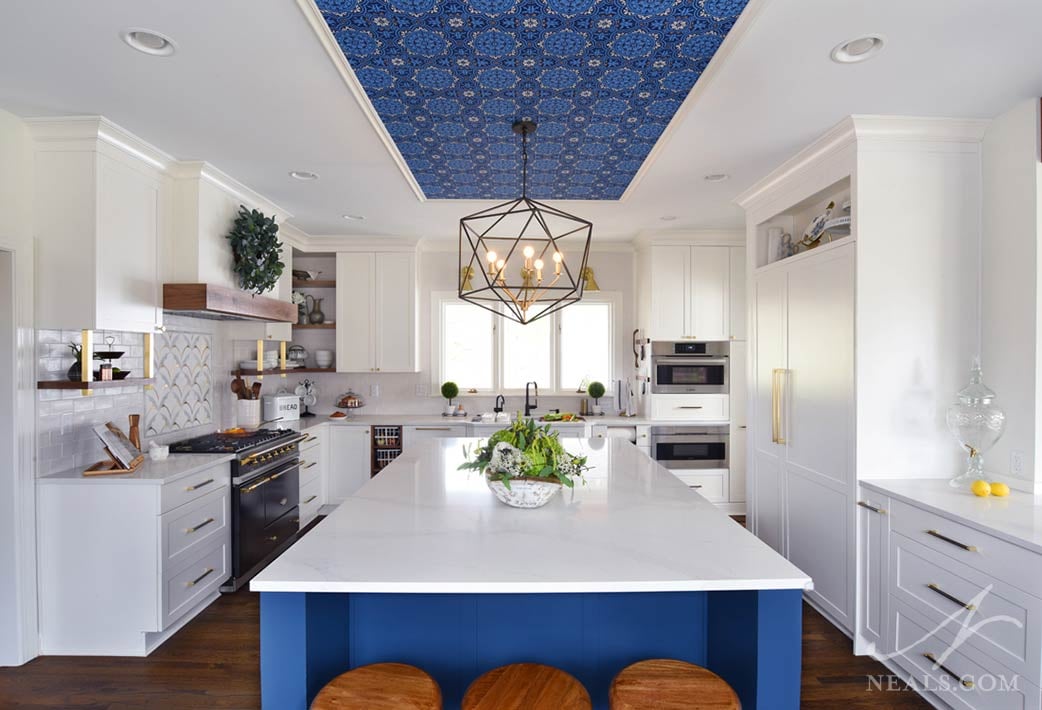 Transitional kitchen with large island and several storage and appliance features.