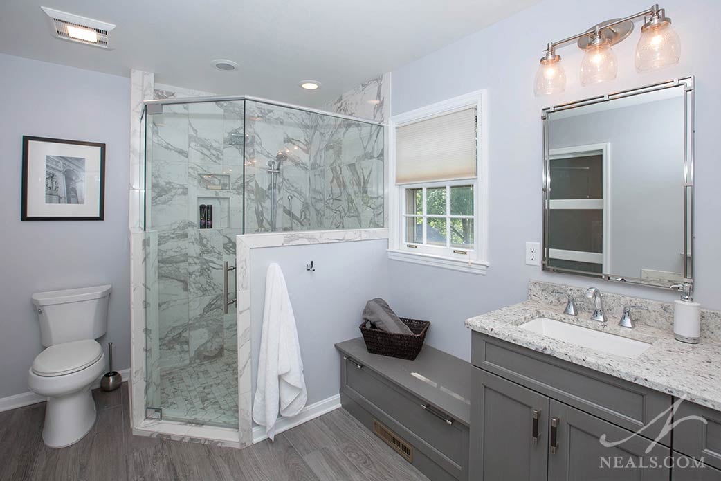 46084_04b Hooks on the shower half wall keep towels at the ready in this Anderson Township bathroom.