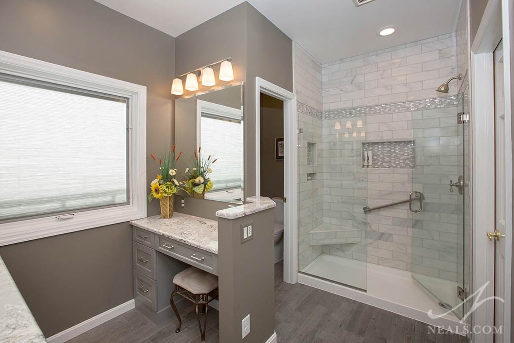 This shower in Pierce Township includes a corner bench and two convenient niches.