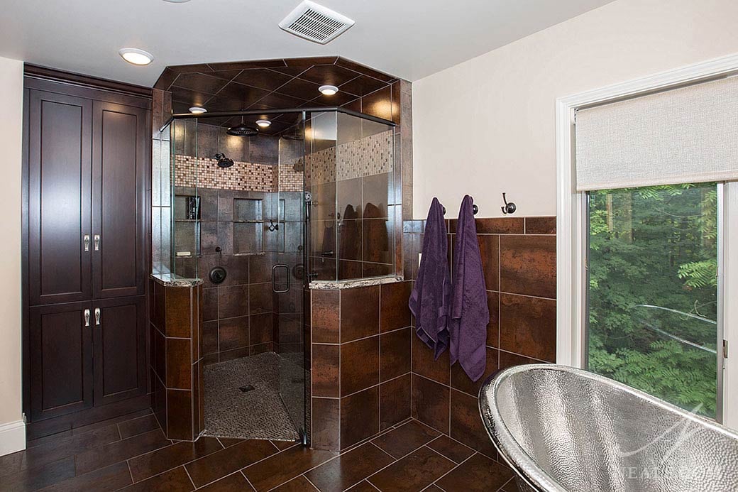 Three recessed lights in the shower of this Indian Hill bathroom provide ample task lighting.