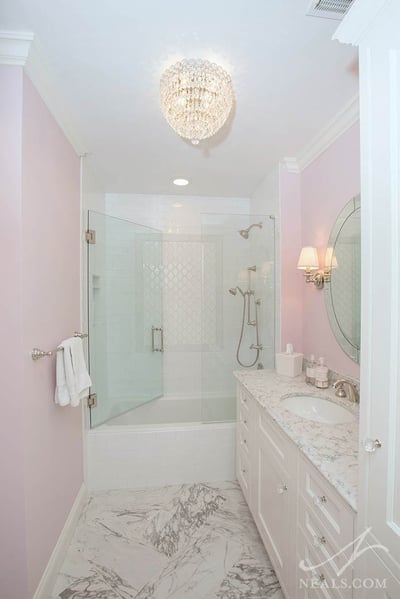 A crystal chandelier in this Indian Hills girl's bathroom adds style and general lighting.
