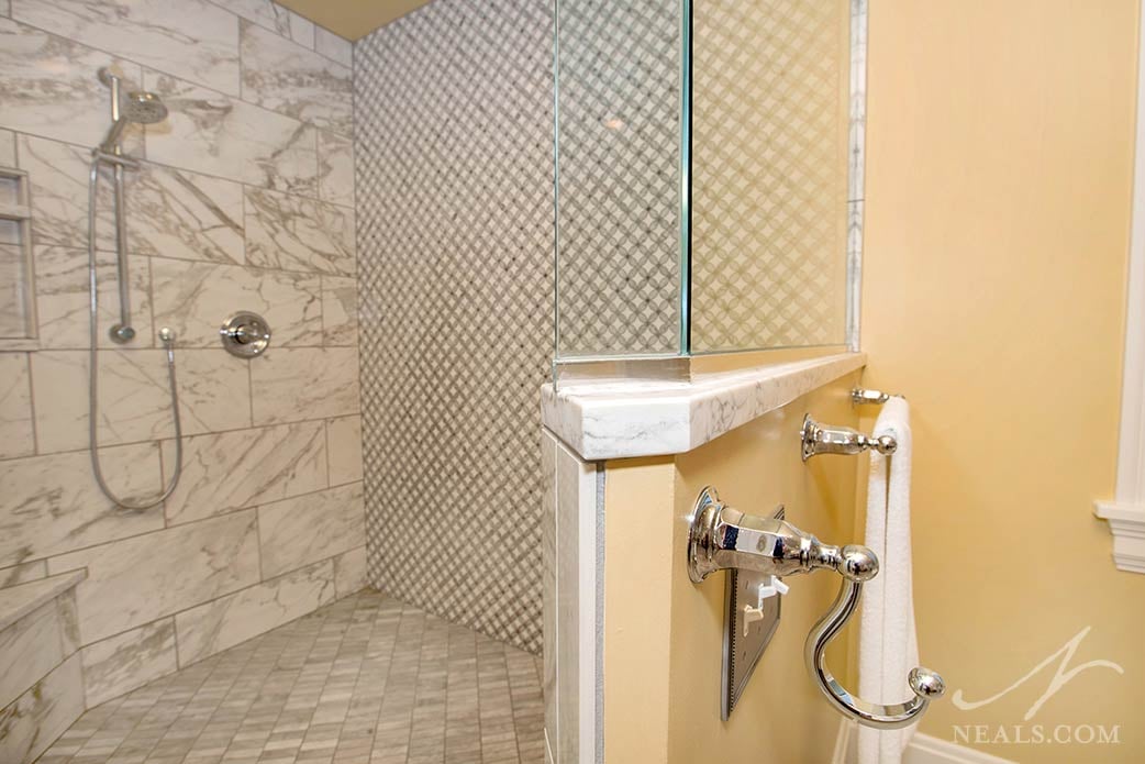 Specialty tile in an interlocked circle design is used as an accent wall in this Hyde Park bathroom.