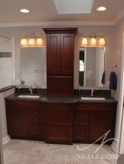A traditional double vanity makes use of a vanity tower that seperates the two sinks while adding storage.