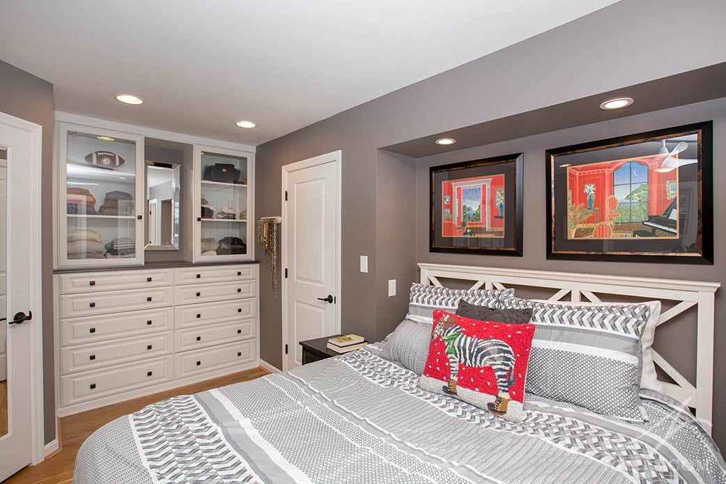 A stylish closet built-in in this Anderson Township master bedroom remodel adds storage in a small space.