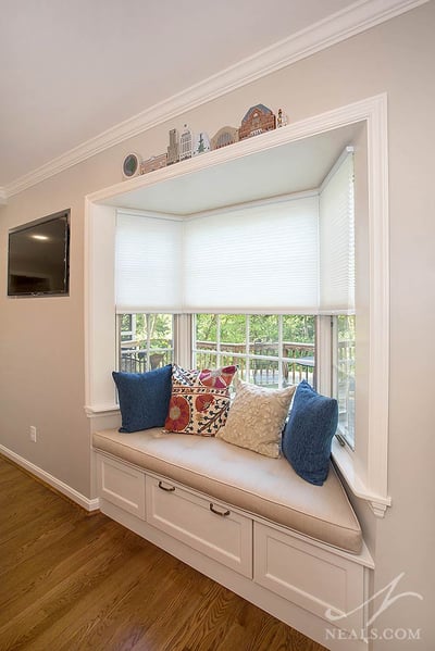 A built-in window seat with a drawer adds interest and storage in this Western Hills kitchen.