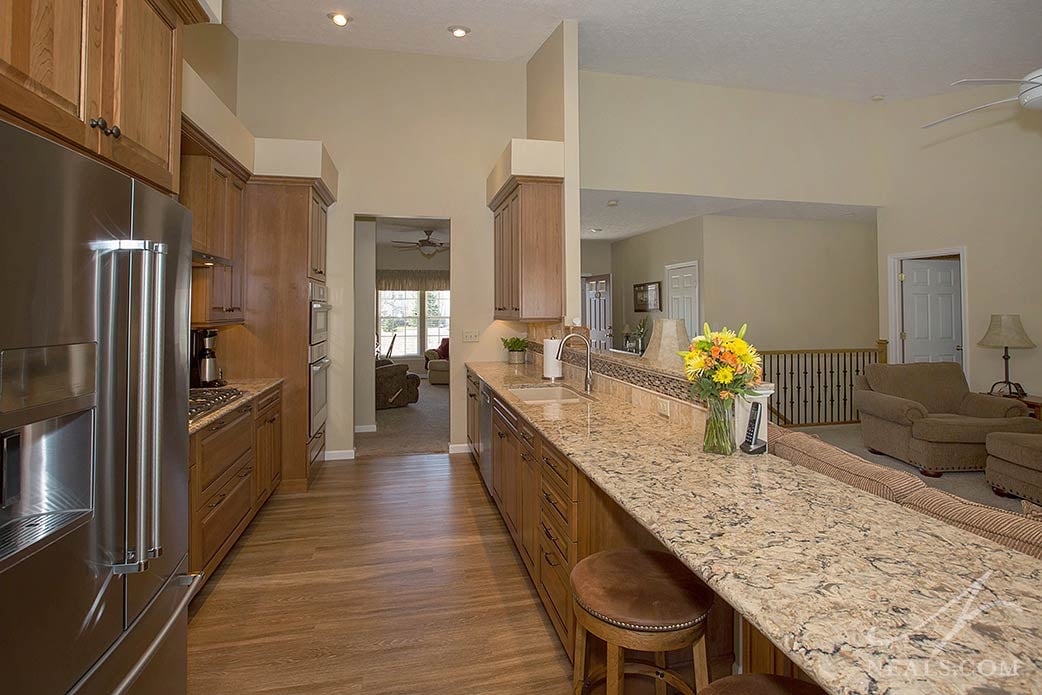 The statement-making peninsula counter of this Lebanon kitchen is Cambria Bradshaw quartz.