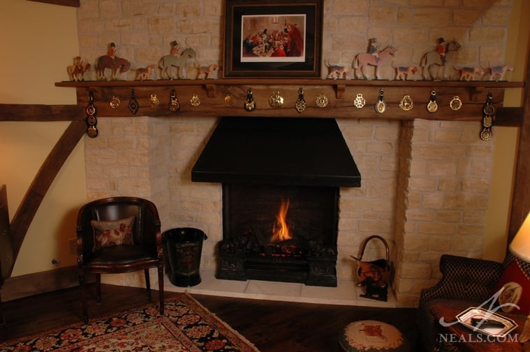 The homeowner's collection of horse medals and traditional English hunting scenes make full use of the wide mantle, and help make it difficult to believe this fireplace exists in an American home.